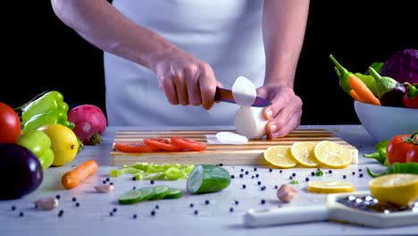 Chef-is-cutting-red-turnip-in-the-kitchen,-slicing-red-radish