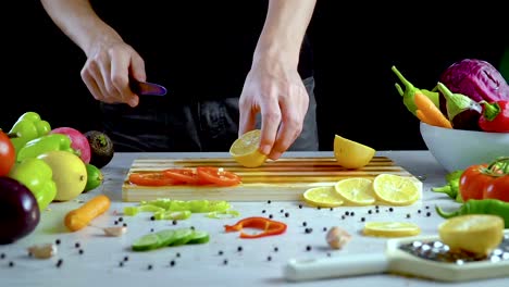 Man-is-cutting-lemon-in-the-kitchen