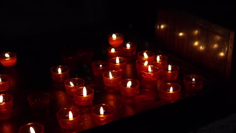 Red-candles-in-the-dark-in-the-Church-in-Europe