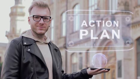 Inteligente-joven-con-gafas-muestra-un-holograma-conceptual-de-un-plan-de-acción