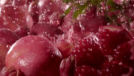 Pomegranate-falling-in-juice-with-splash-between-pomegranate.-Slow-motion