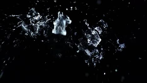 Falling-of-cubes-of-ice-on-a-black-background.-Slow-motion.