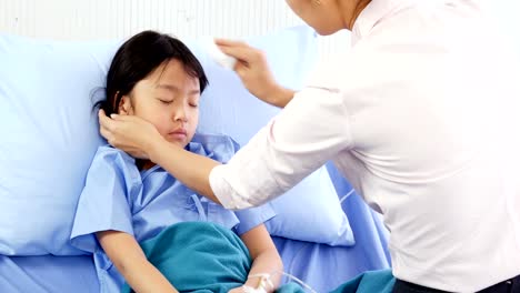 Little-girl-was-taking-care-by-her-mother-at-hospital.-People-with-Healthcare-and-Medical-Concept.