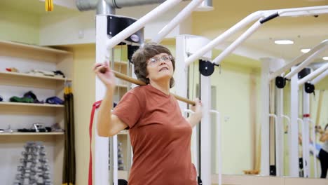 Senior-woman-doing-exercises-in-fitness-room.