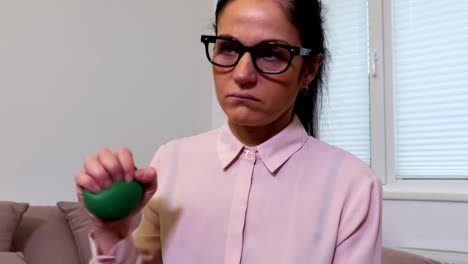 Depressed-woman-squeezing-stress-ball