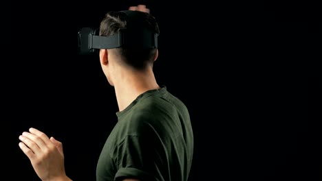 Portrait-of-Young-Man-using-VR-Glasses-on-Black-Background.-Male-Virtual-Reality-Console-Headset-Play-3D-Gaming-Innovation-Internet-Entertainment-Technology