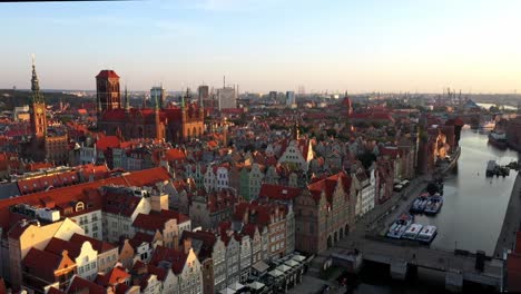 Gdansk-old-city-in-the-rays-of-the-rising-sun,-aerial-view-of-the-old-city-streets