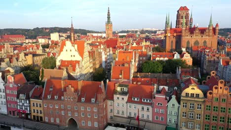 Gdansk-old-city-in-the-rays-of-the-rising-sun,-aerial-view-of-the-old-city-streets