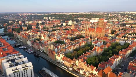 Gdansk-old-city-in-the-rays-of-the-rising-sun,-aerial-view-of-the-old-city-streets