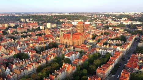 Gdansk-old-city-in-the-rays-of-the-rising-sun,-aerial-view-of-the-old-city-streets