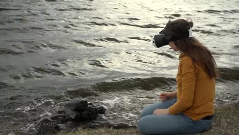 A-young-woman-uses-virtual-reality-glasses-next-to-strong-waves.