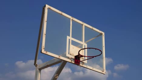 Basketball-cage-against-blue-sky-on-sunny-summer-day