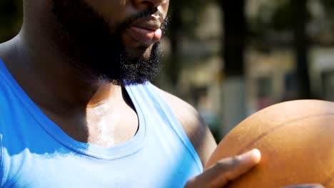 Concentrated-black-man-sighs,-preparing-for-throw-on-basketball-court,-sports