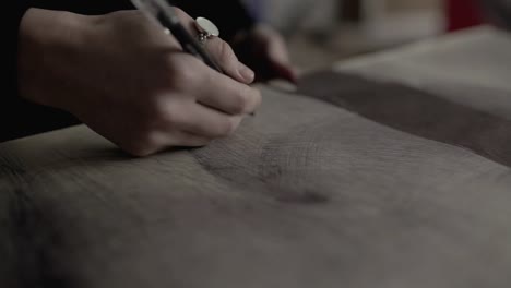 Close-up-of-womans-hand-painting-in-her-studio