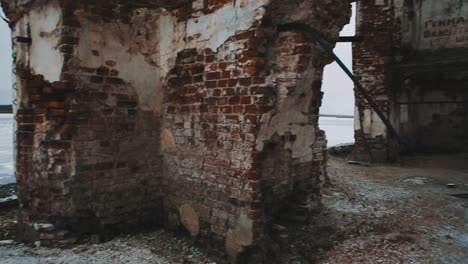 Inside-abandoned-orthodxal-chapel,-red-bricks-walls,-cold-cloudy-day