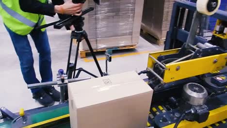 Cardboard-boxes-on-conveyor-belt-in-factory.-Clip.-Production-line-on-which-the-boxes-move-in-a-spiral