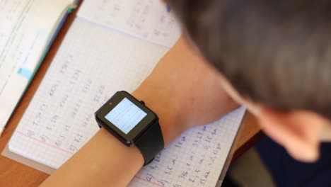 Learner-doing-homework-with-Smart-Watch-device