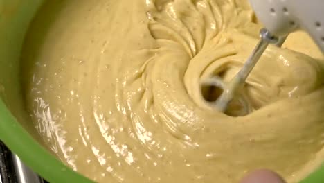 Mixing-the-dough-with-a-mixer.-Cooking-of-cream-dough-with-a-mixer,-slow-motion-shooting-in-180fps.-Beautiful-waves-on-a-thick-liquid.-Standard-dough-for-cupcakes.