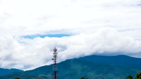 Time-Lapse-Phone-Tower-background-is-clouds,-rain-and-mountains.