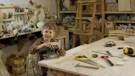 Smiling-Boy-Posing-in-Carpentry-Workshop