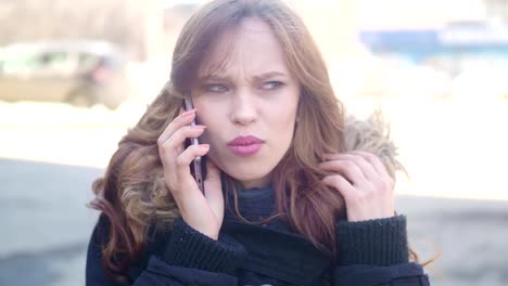 the-girl-on-the-street-talking-on-the-phone.-quarrels-and-gets-upset