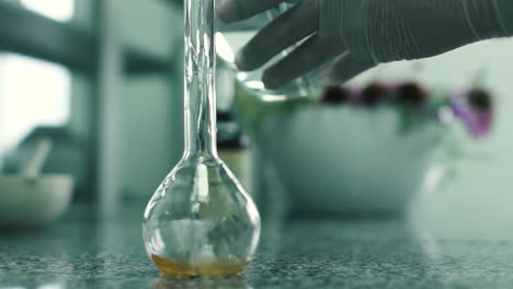 Laboratory-assistant-pours-the-water-into-the-flask