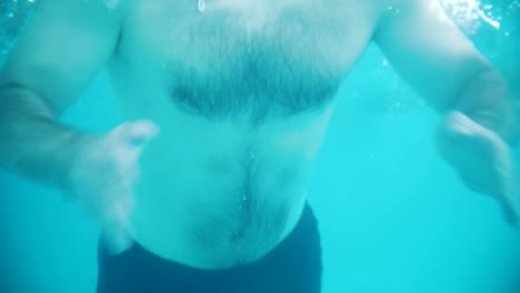 Disabled-man-swims-in-a-swimming-pool.-The-butterfly-stroke.-Underwater-shot