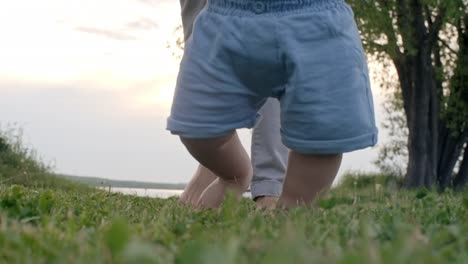 Woman-and-Baby-Walking-on-Grass