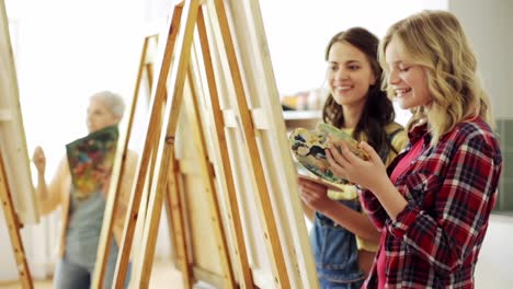 students-with-easels-painting-at-art-school