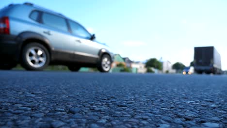 Blurred-cars-go-one-by-one-on-the-road.-Vehicles-drive-along-asphalt-road.-Traffic-in-highway.-Low-angle-view-Slow-motion