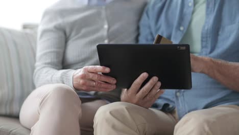 senior-couple-with-tablet-pc-and-credit-card