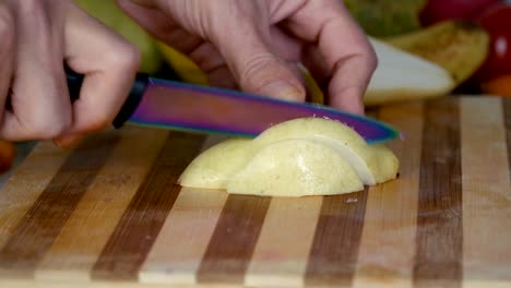 Man-is-slicing-pear-in-slow-motion