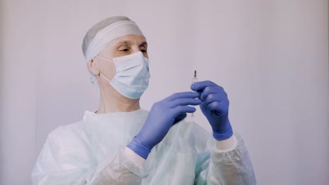 The-doctor-holding-a-syringe-with-the-vaccine.-He-is-preparing-to-give-the-patient-an-injection.-Remove-extra-air-from-the-needle