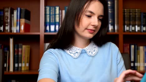 pretty-girl-using-computer-tablet-in-the-library-or-in-the-office.