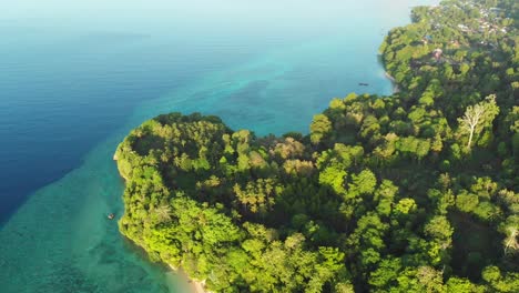 Aerial-flying-over-tropical-paradise-pristine-beach-rainforest-blue-lagoon-at-Banda-Island,-Pulau-Ay.-Indonesia-Moluccas-archipelago,-top-travel-destination,-best-diving-snorkeling.