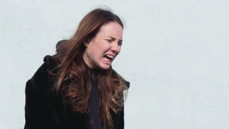 Portrait-of-a-Young-Woman-Screaming-in-Angst-Outdoors