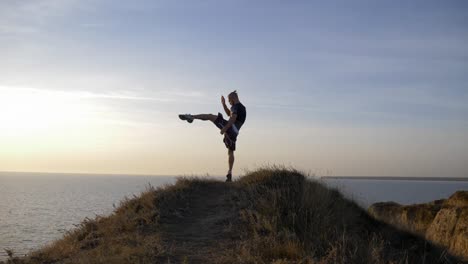 boxing-workout,-strong-sportsman-practicing-boxing-hits-before-sparring-on-hill-near-river