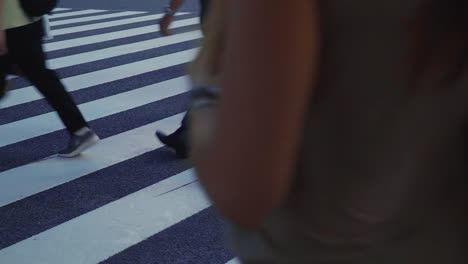 Close-up-shot-of-a-busy-pedestrian-street-crossing-in-Japan-on-a-hot-summer-day.