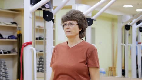 Senior-woman-doing-exercises-in-fitness-room.