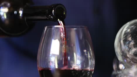 Wine.-Closeup-Of-Red-Wine-Pouring-Into-Glass-From-Bottle