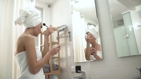 Makeup.-Woman-Applying-Powder-On-Face-Skin-At-Bathroom