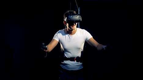 A-man-moves-in-VR-equipment.-Virtual-reality-gaming-concept.