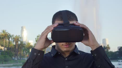 Young-man-taking-off-his-VR-glasses-and-looking-at-camera