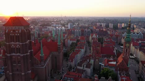 Gdansk-old-city-in-the-rays-of-the-rising-sun,-aerial-view-of-the-old-city-streets