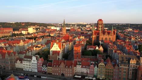 Gdansk-old-city-in-the-rays-of-the-rising-sun,-aerial-view-of-the-old-city-streets