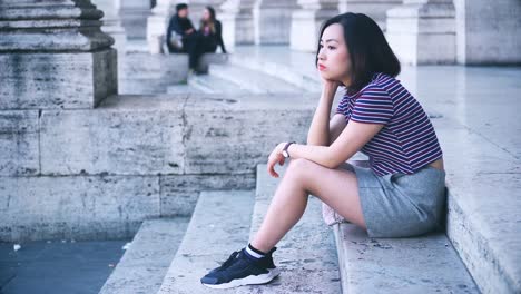 profile-of-bored-and-thoughtful-Chinese-woman-alone,-waiting-for-someone