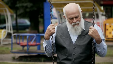 Sad-old-man-swings-on-seesaw-in-slowmotion