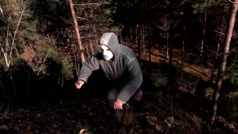 Man-in-scary-Halloween-mask-and-machete-step-up-on-the-hill