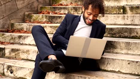 businessman-lying-on-steps-with-laptop