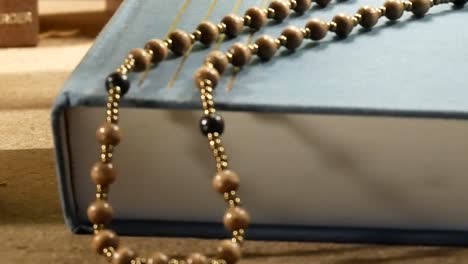 Wooden-Rosary-on-the-Bible.-Panning